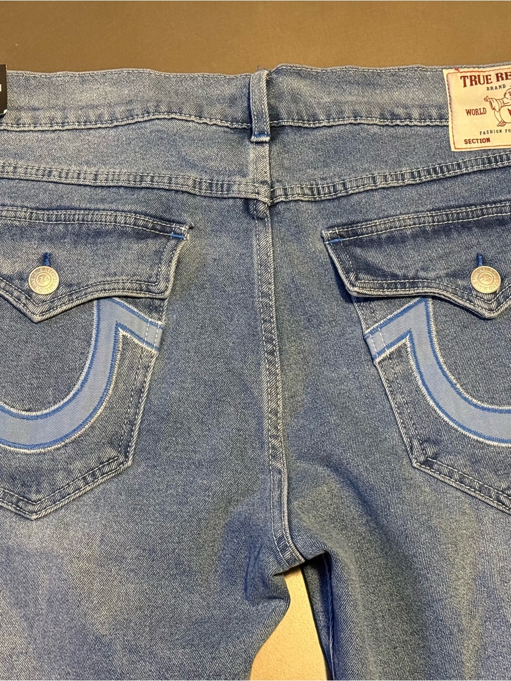 True Religion Men's Light Blue Denim Jeans with Signature Back Pocket Embroidery